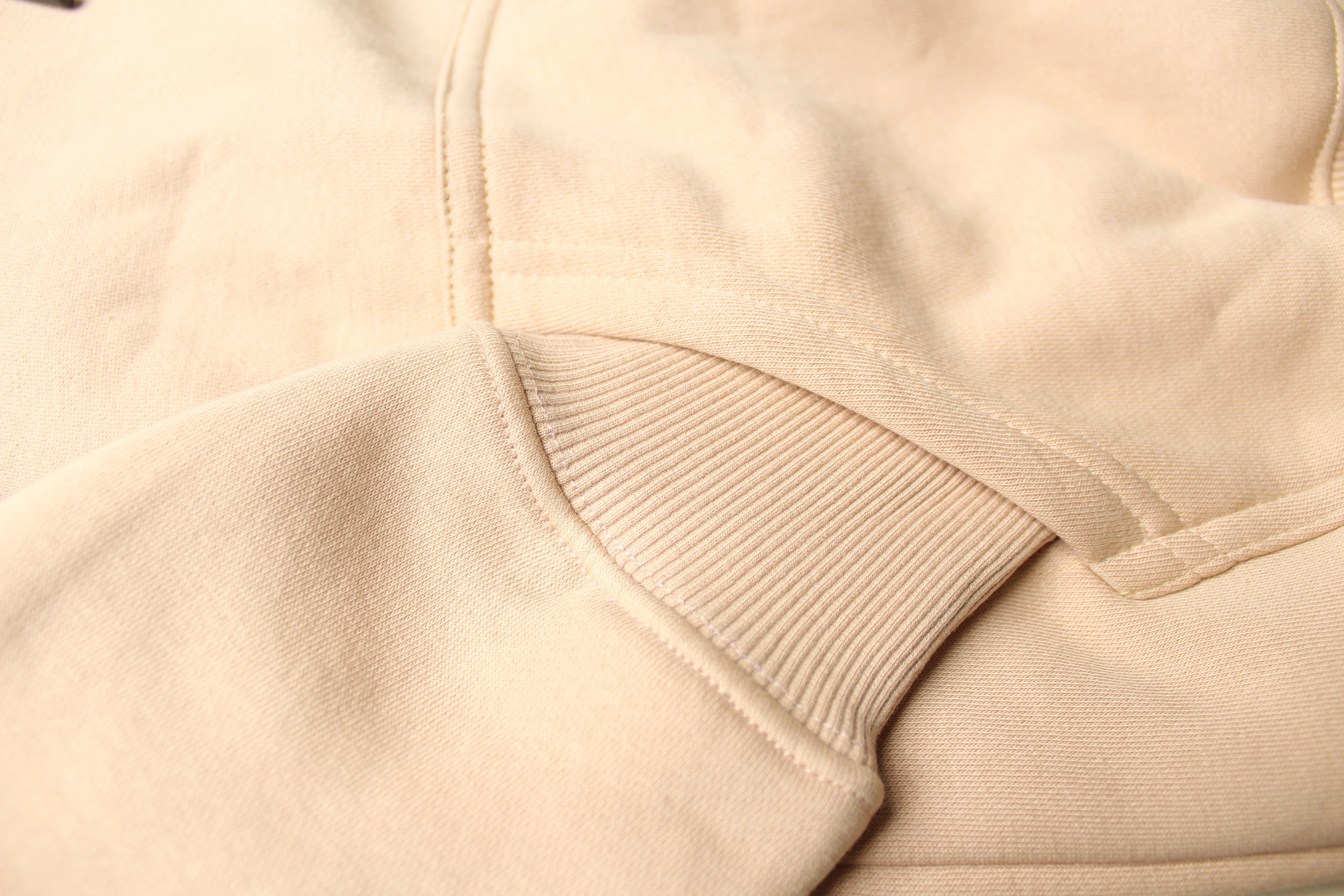 Close-up of beige fabric with a focus on texture and stitching