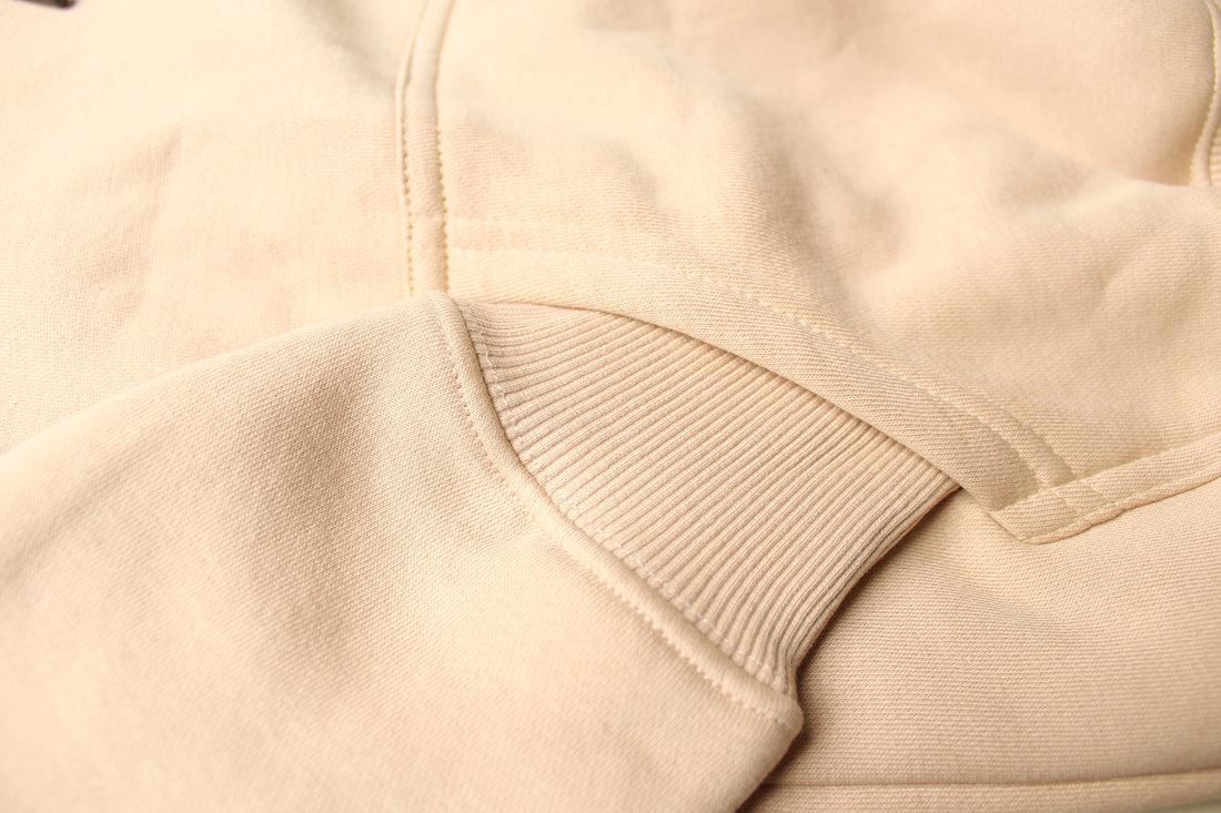 Close-up of beige fabric with a focus on texture and stitching